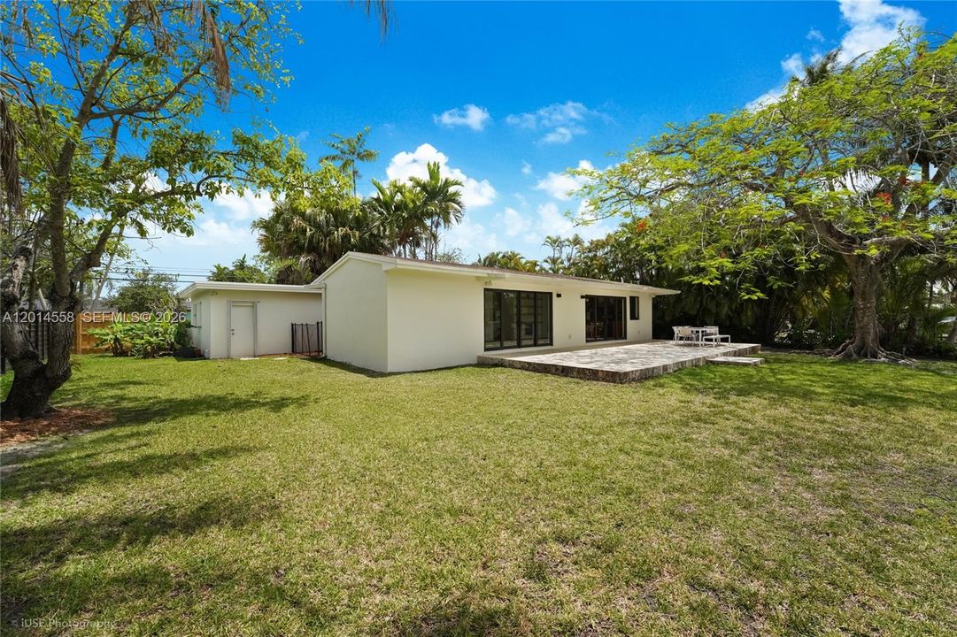 Spacious backyard with detached garage, perfect for family fun.