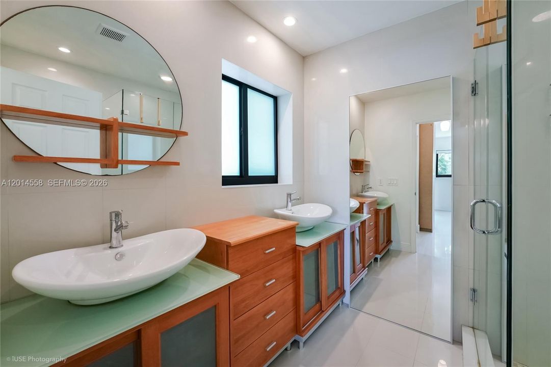 Primary bathroom with double sinks and shower
