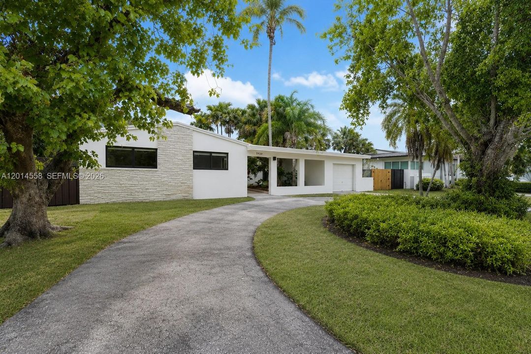 Front of the property shows circular driveway and a detached one car garage great for storage.
