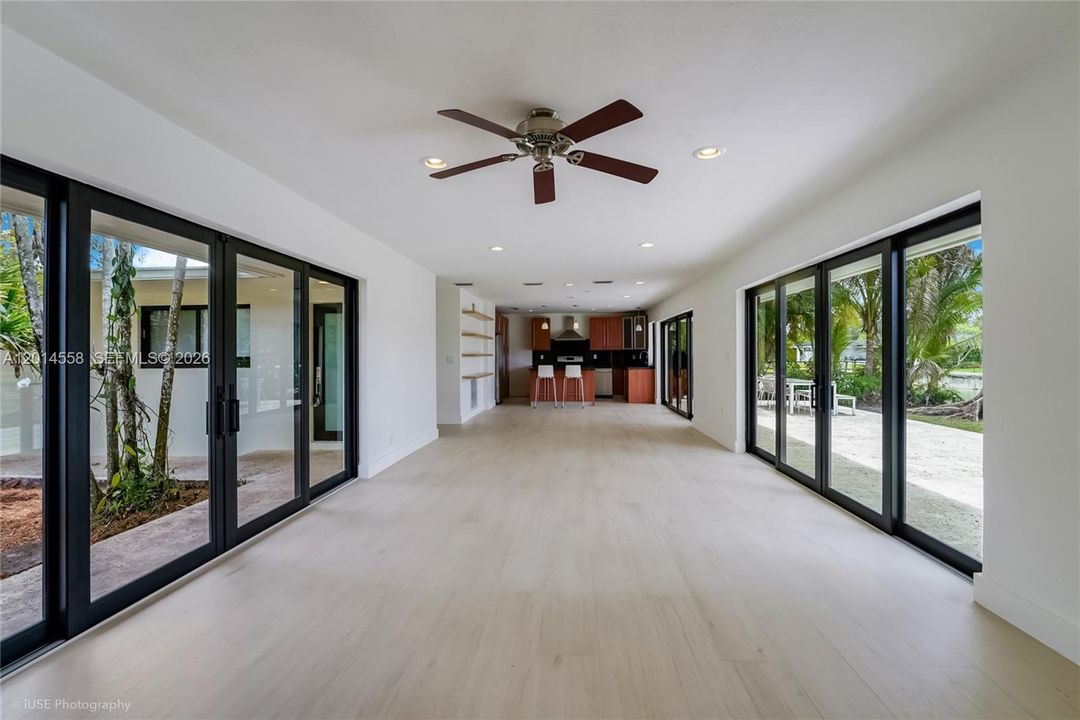 Spacious open-concept design seamlessly blends kitchen, dining, and living areas, flooded with abundant natural light.