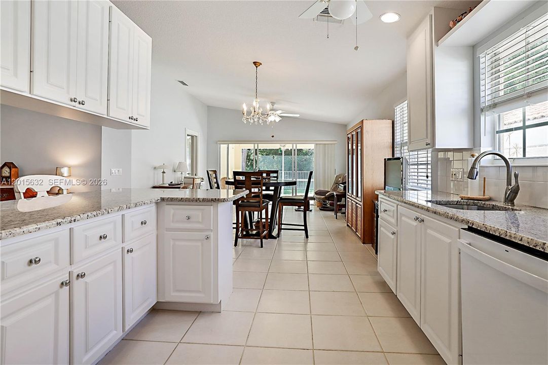 kitchen leads to dining area and family room with slider out to patio & peaceful private preserve view.