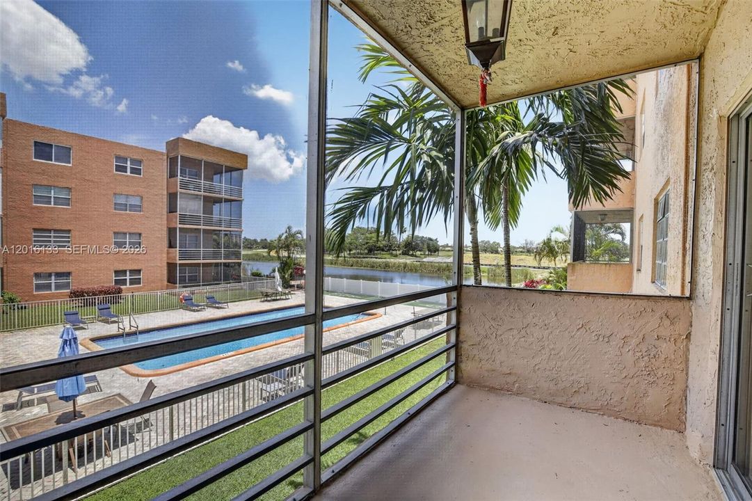 Wake up to peaceful pool and lake views from this bright 2-bedroom, 2-bath corner condo.