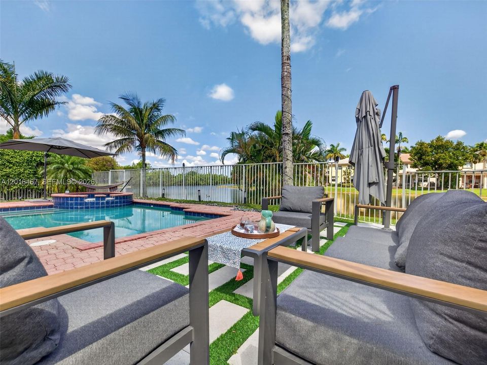Gorgeous backyard, with pool and patio area overlooking  tranquil water views, perfect to relax after a long day!
