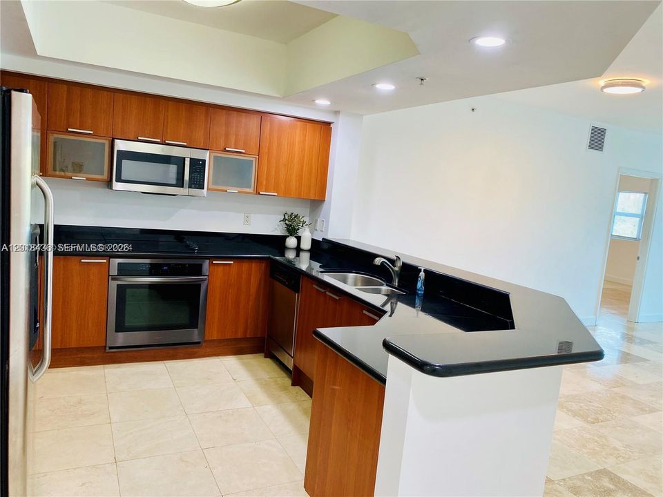 Open kitchen with stainless steel appliances and extra cabinets space