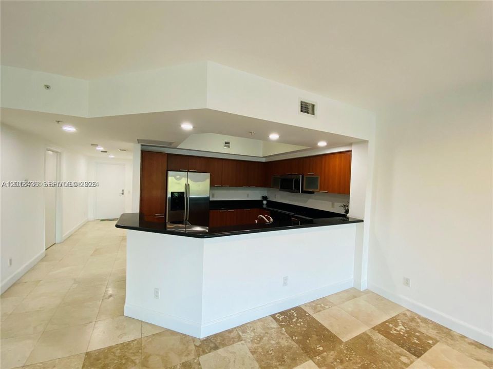 Open kitchen with stainless steel appliances and extra cabinets space