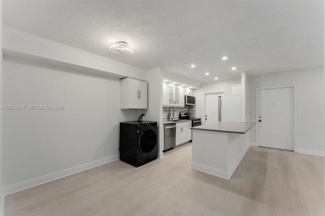 Open updated kitchen with washer/dryer