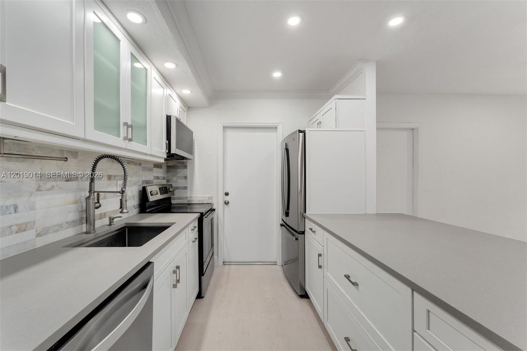 Fully-equipped spacious open kitchen with new appliances.