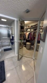 Primary bedroom deep organize mirror walk-in closet & next to a linen closet