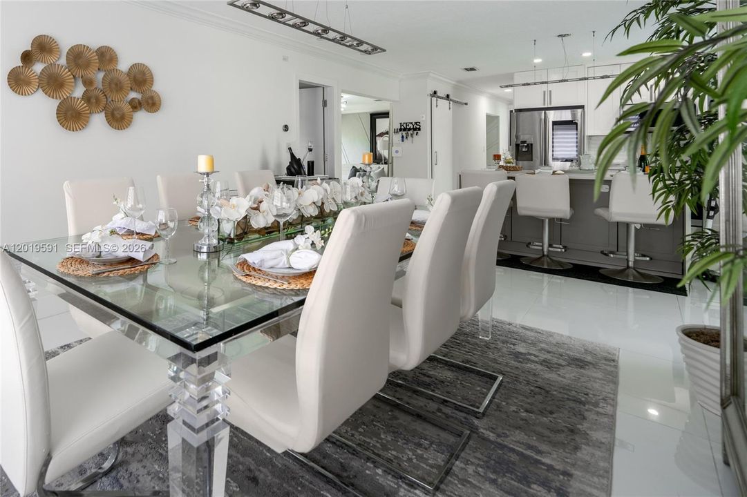 Elegant dining area with modern furnishings, open layout, and bright luxury waterfront home design.