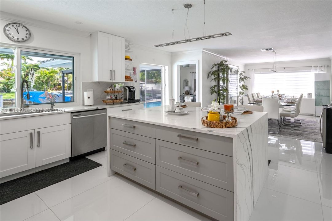 Spacious gourmet kitchen featuring oversized island, quartz countertops, and seamless indoor-outdoor flow.
