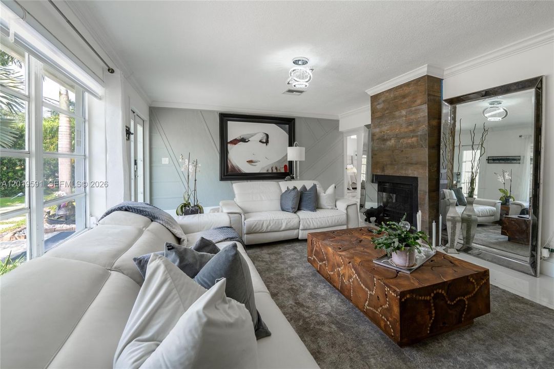 Bright modern living room with open-concept design, elegant finishes, and poolside natural light.