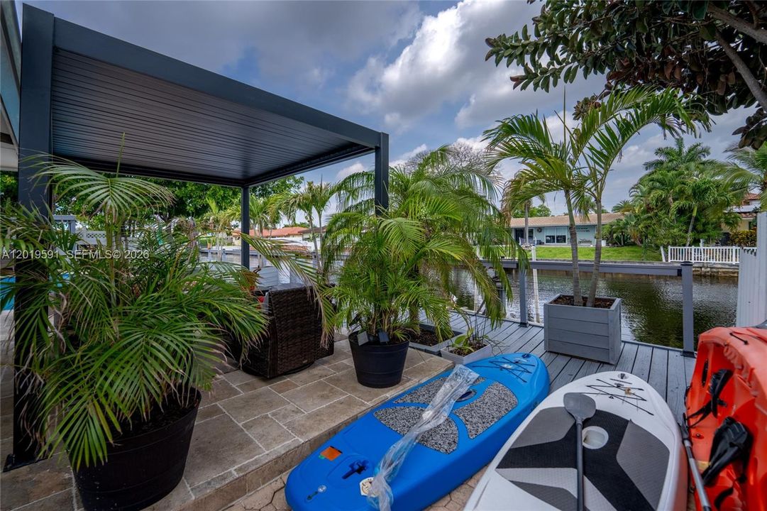 Tropical outdoor lounge and waterfront patio area perfect for relaxing, entertaining, and enjoying Florida living.