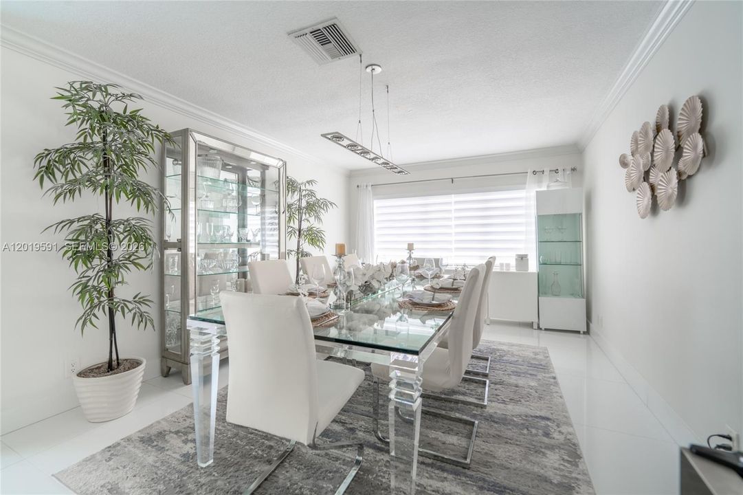 Sophisticated dining area with modern décor, natural lighting, and perfect space for gathering and entertaining.