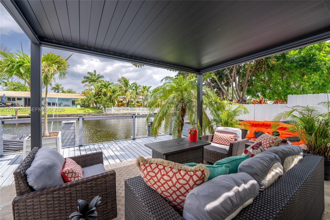 Covered waterfront patio designed for relaxing outdoor living and luxury vacation entertaining.