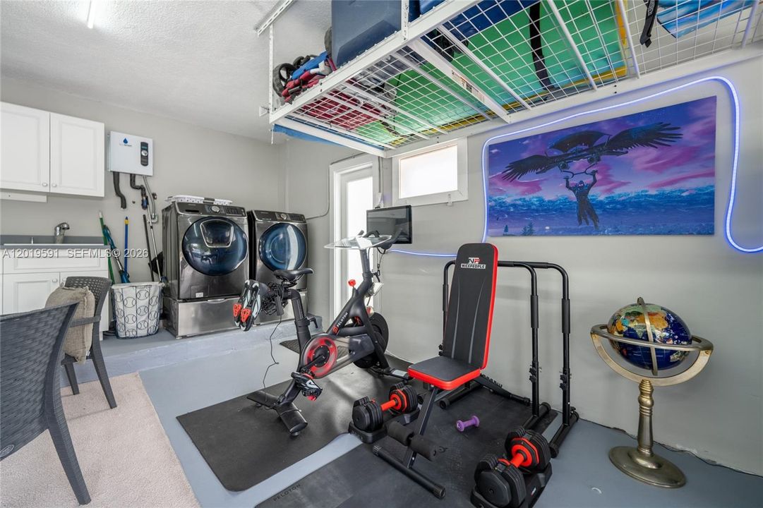 Private fitness room with workout equipment, wellness space, and modern luxury vacation amenities.