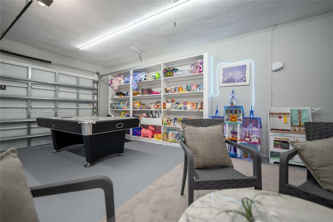 Luxury game room featuring arcade basketball, entertainment space, and family-friendly vacation amenities.