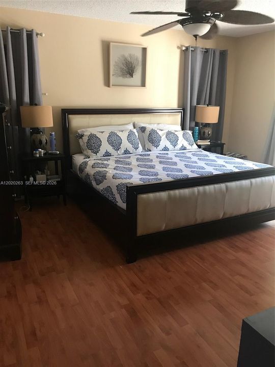 Master bedroom with sliding doors out to pool area