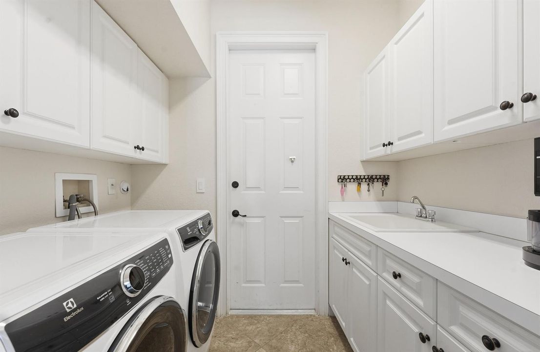 laundry room with cabinets