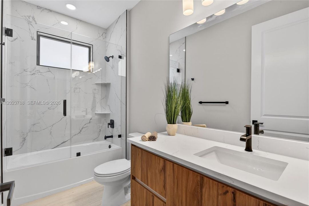 THIRD GUEST BATHROOM located off the hallway offers convenient access for family, guests & everyday living!
