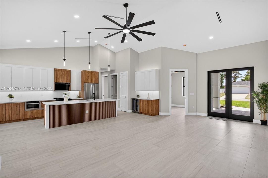 GORGEOUS CHEF’S KITCHEN showcases sophisticated CUSTOM CABINETRY w/ NATURAL WOOD-GRAIN finish paired w/ sleek WHITE FLAT-PANEL UPPER CABINETS.