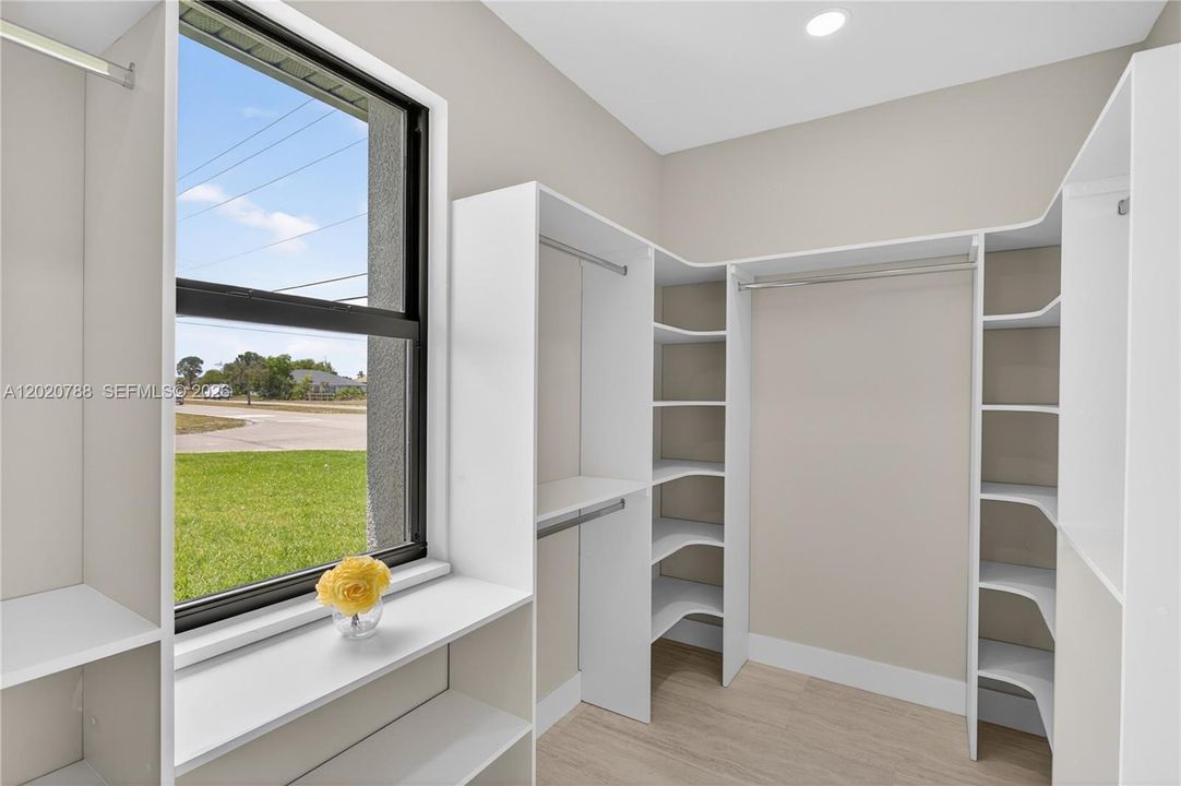 WALK-IN CLOSET w/ BUILT-IN SHELVING & HANGING RACKS