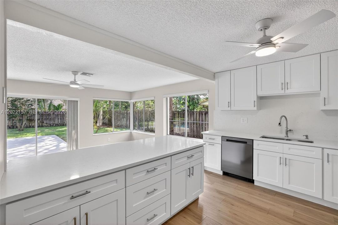 New beautiful kitchen w/ White Shaker style, slow close cabinets, quartz counters, and BRAND NEW appliances connected to family room