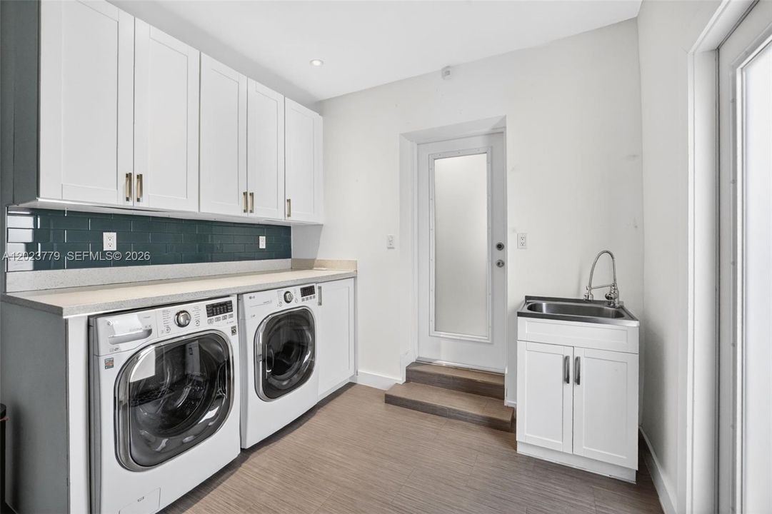 Laundry area w/ granite counter and extra storage in garage. Work sink, Garage has extra AC system