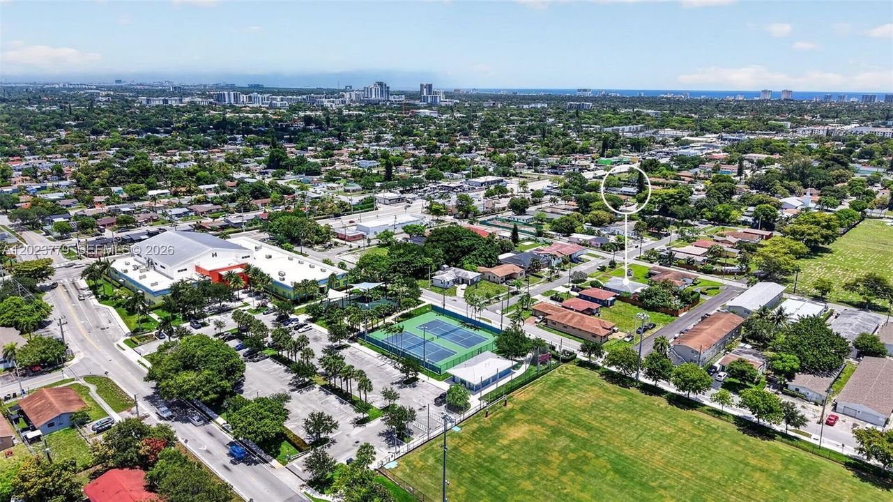 View to the city park with tons of amenities (Gym, Tennis, Playgrounds etc for just $11/month). Notice the parking lot nearby as well