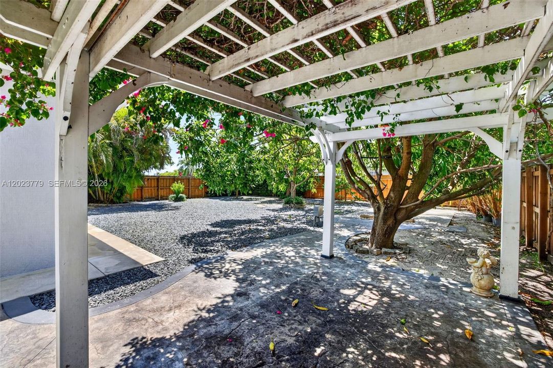 Pergola w/ flower vines growing over it for extra seating area or a great place for outdoor workouts or worksite for your crafting and hobbies