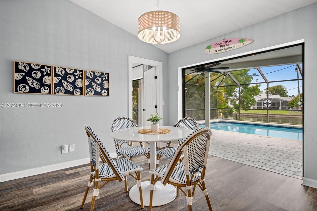 Dining area open to the lanai and pool