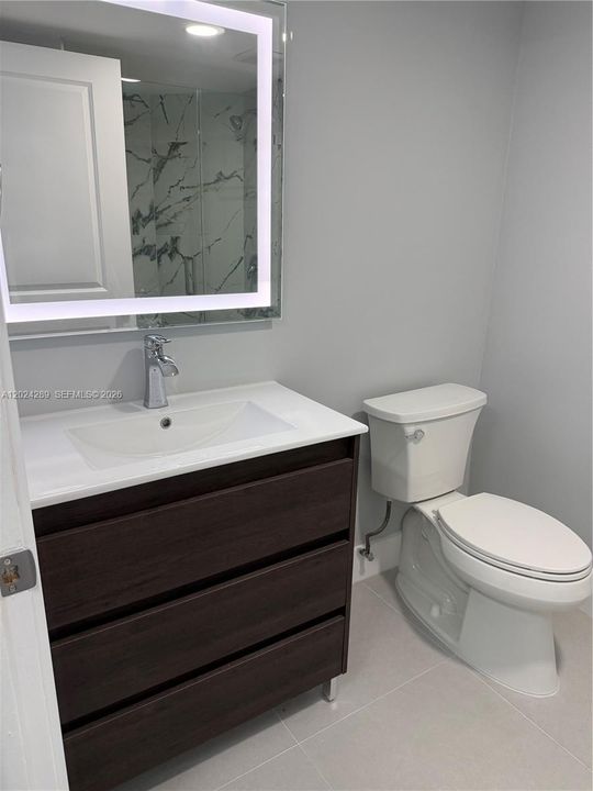 Hallway bathroom with LED mirrors