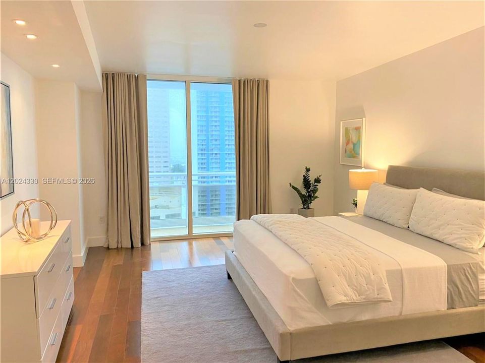 Spacious Primary Bedroom - Wood Floors - Recessed Lighting - Balcony