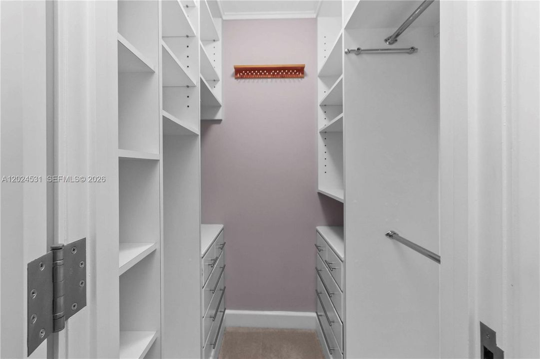 Custom walk-in closet with built-in shelving and drawers
