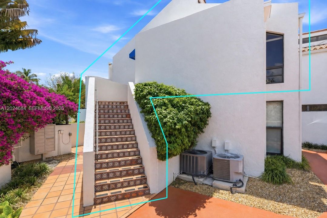 Private staircase to unit's entry. Mediterranean/Santorini-inspired gated enclave