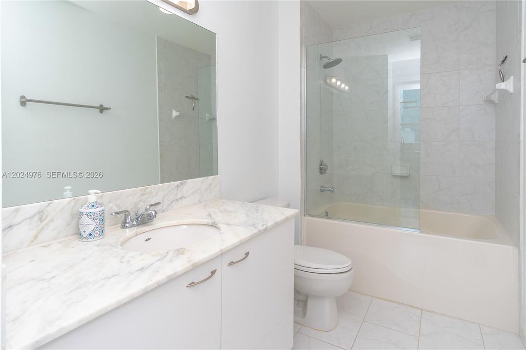 Guest Bathroom w/ Marble Countertops and Custom Tile + Glass Shower (You won't find this in other units)
