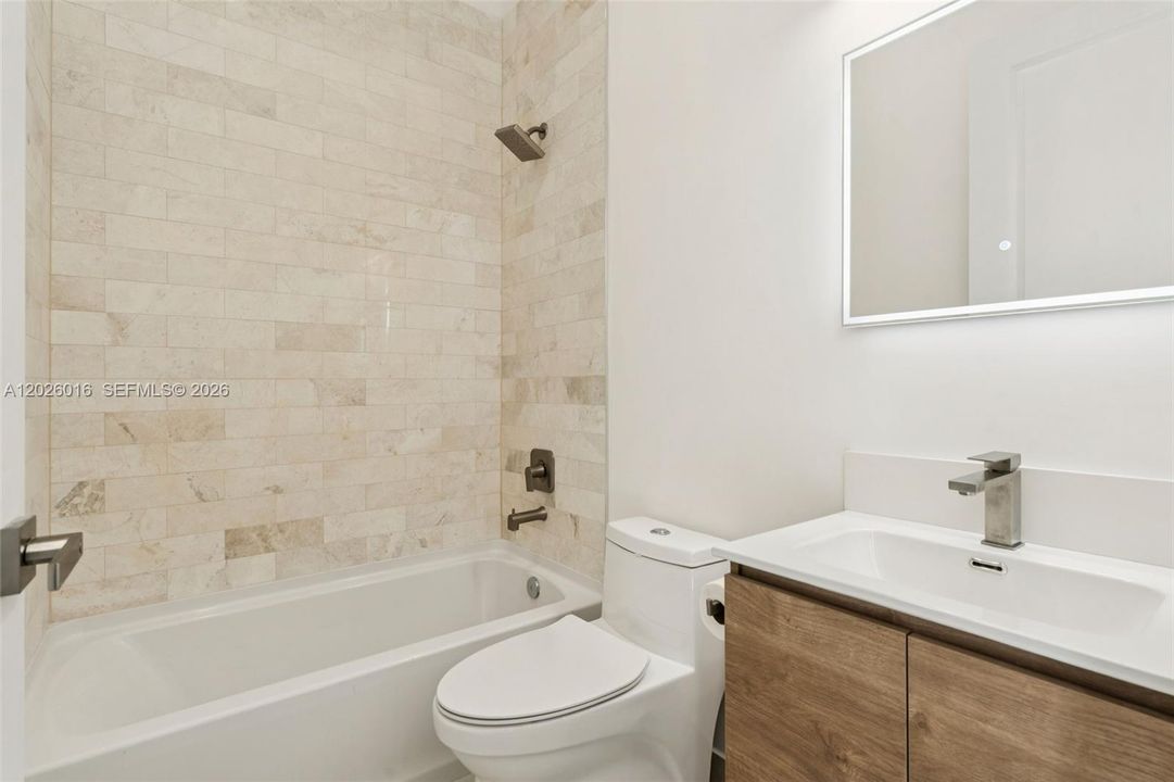 Photos shown are of a completed unit with the same layout and styling; the available unit is currently under construction and may vary.