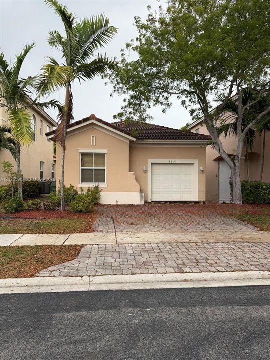 This photo shows the 1-car garage and 2-car front driveway.