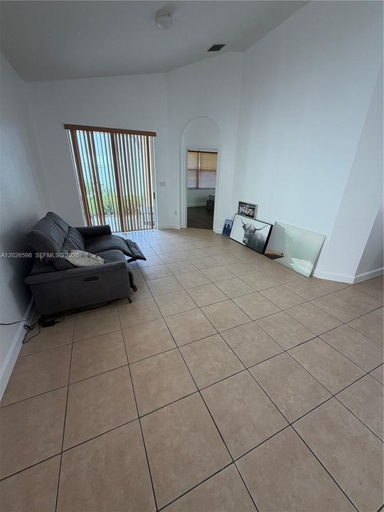 This is the living room with the patio in the background on the left and the primary suite on the right.