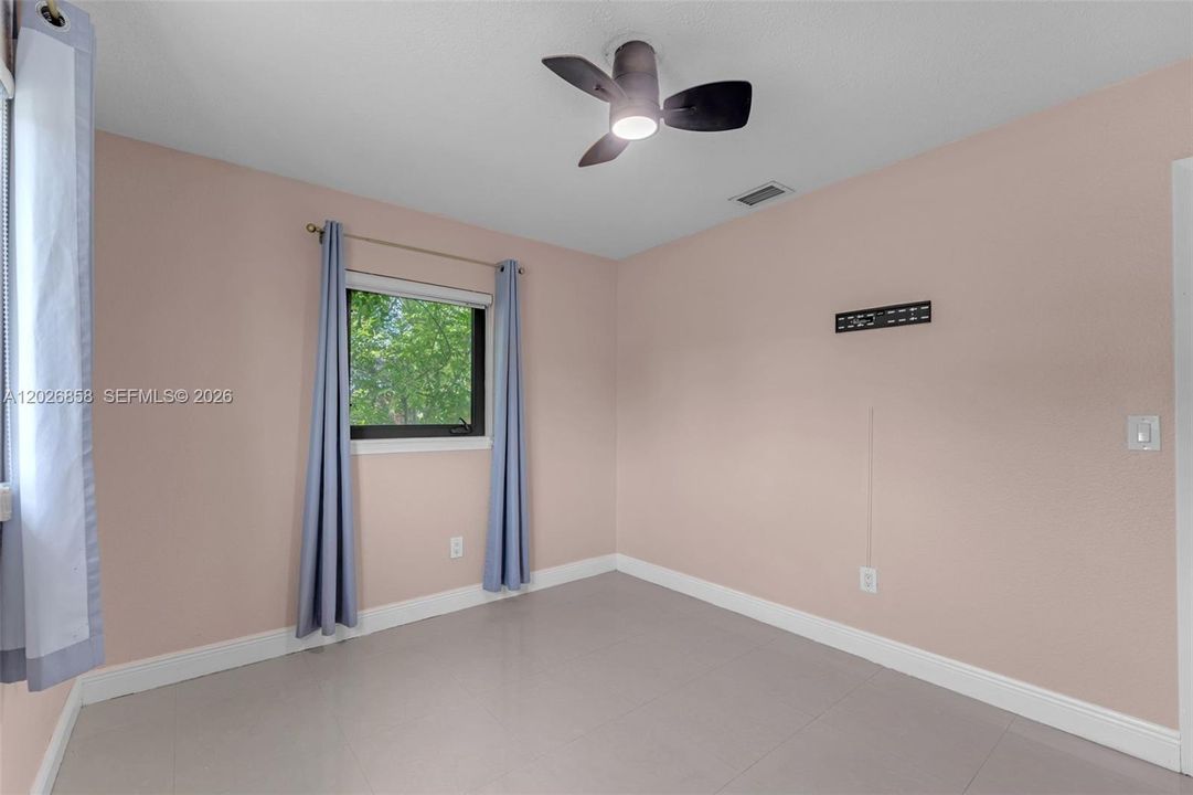 Versatile bedroom ideal for guests, a home office, or growing family needs.