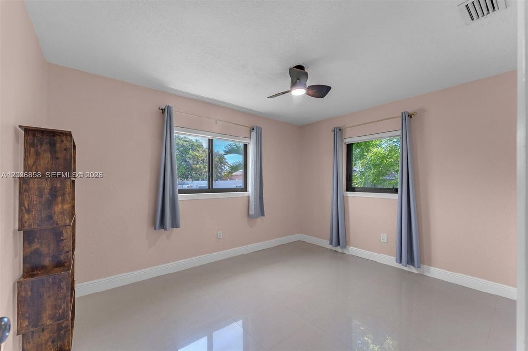 Generously sized bedroom with dual windows providing abundant natural light.
