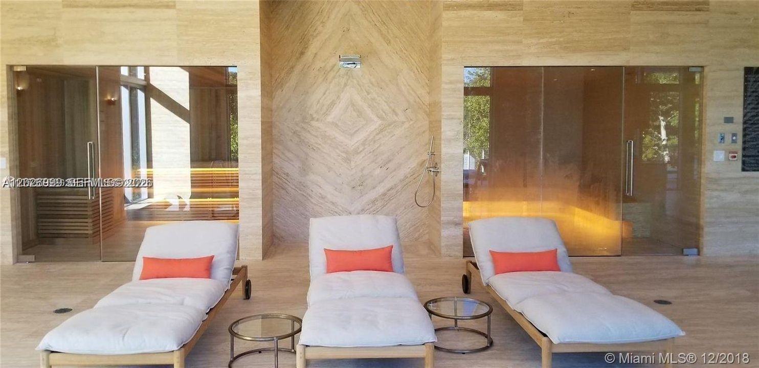 Elegant spa area with wood-paneled saunas and lounge seating for post-workout recovery or unwinding.