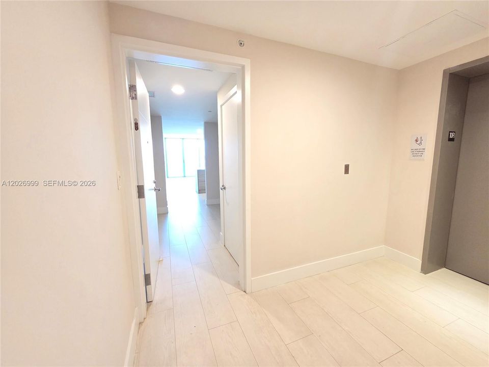 Foyer and hallway leading into the main living area and kitchen, featuring recessed lighting and a seamless transition into the open-concept layout.