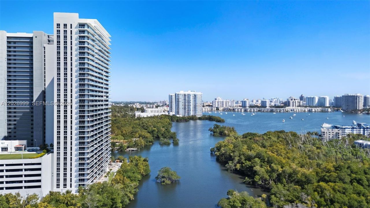 Sweeping aerial views highlight the property’s waterfront location, nearby waterways, and surrounding high-rise skyline.