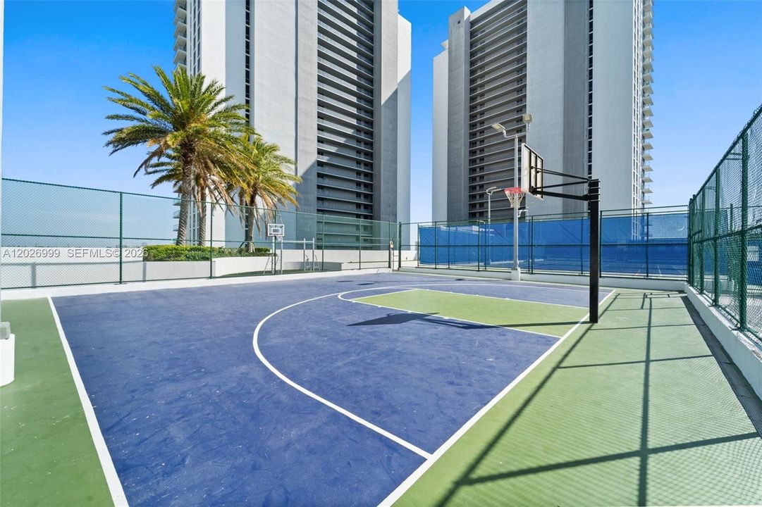 A dedicated outdoor basketball court offers additional space for recreation within the building’s amenity collection.