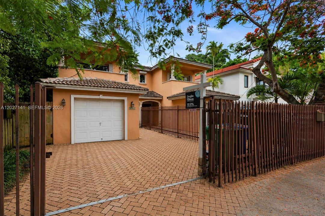 View of the spacious backyard, paved patio and covered terrace