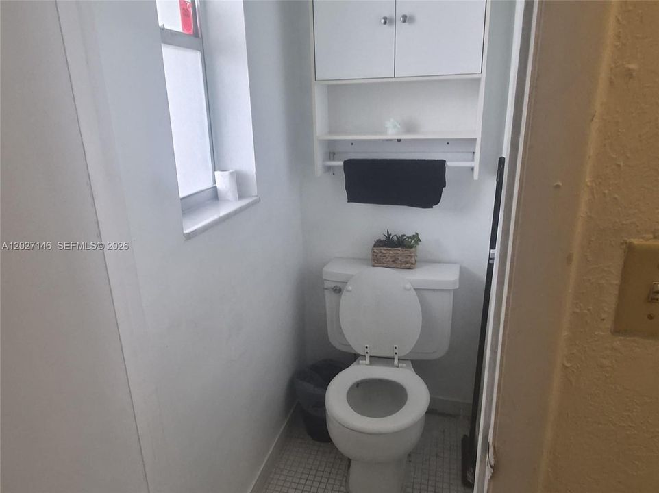 Convenient guest half-bathroom—a highly sought-after secondary layout feature for 1-bedroom models
