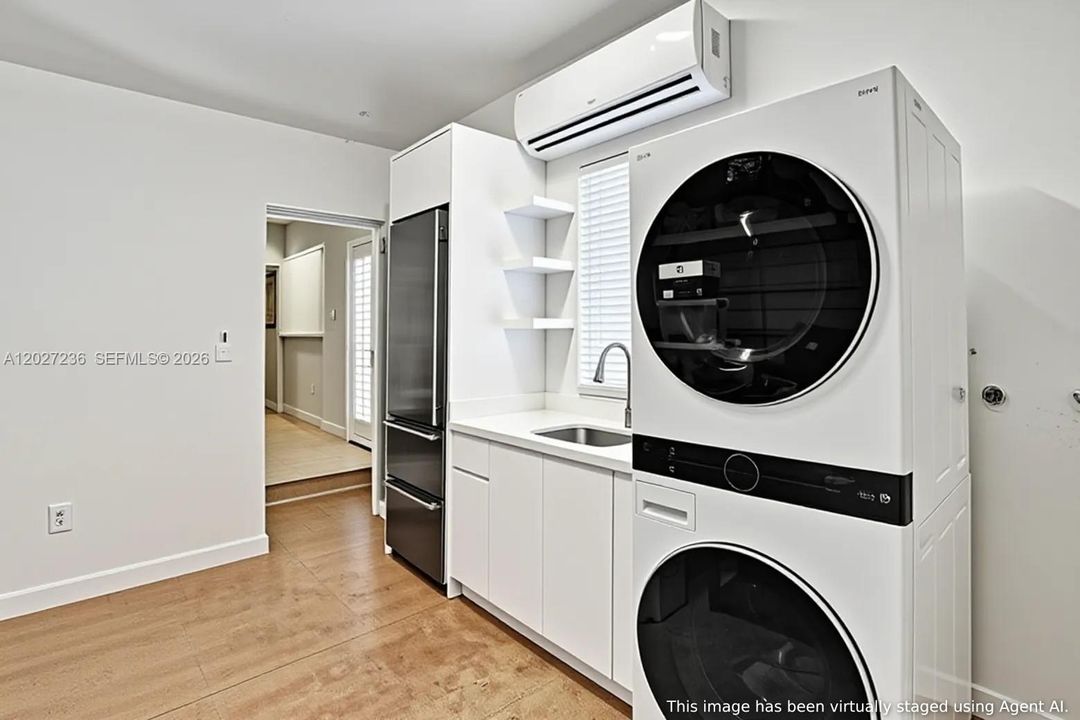 2 Car Garage has a stackable LG Washer/Dryer & an extra Subzero Refrigerator