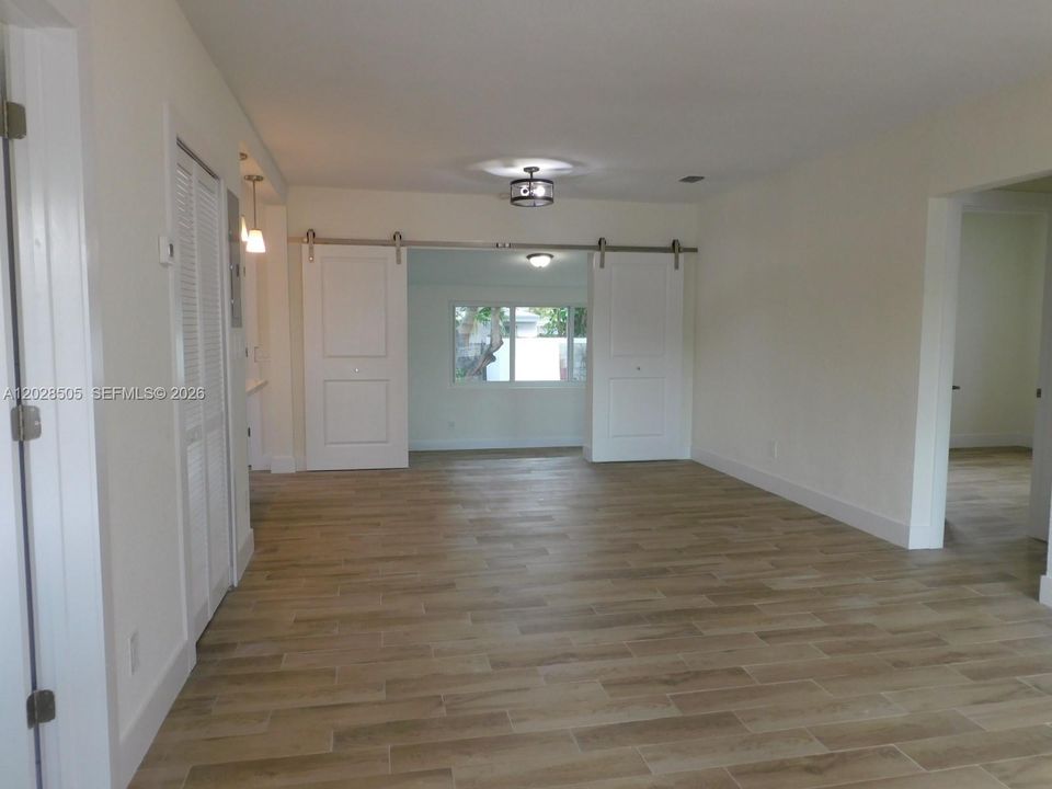 Entry way view to living room and dining room.  All neutral colors throughout, tiled floors for easy care.