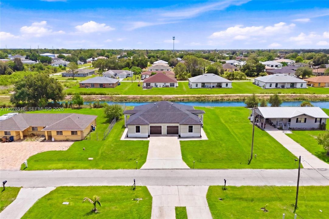 Stunning aerial view showcasing the modern duplex design with peaceful canal backdrop.