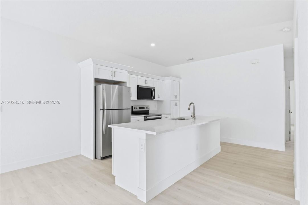 Enjoy effortless entertaining in this spacious living and kitchen area.